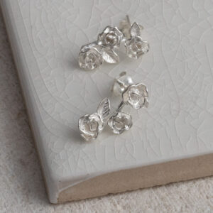Sterling Silver Triple Rose Studs on a white background.