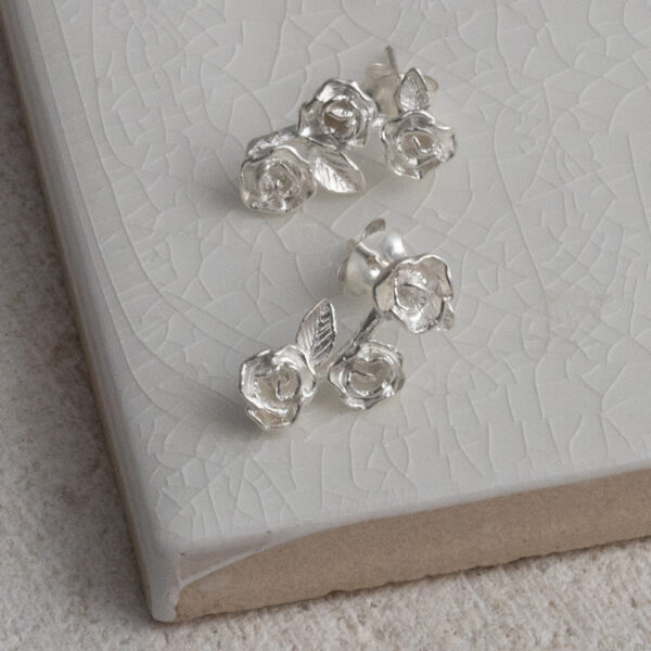 Sterling Silver Triple Rose Studs on a white background.