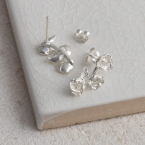 Sterling Silver Triple Rose Studs on a white background.