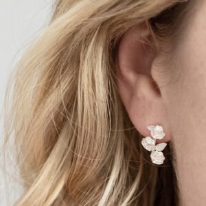 Sterling Silver Triple Rose Studs on a model.