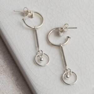 Sterling Silver Heart and Bar Studs on a white tile background.