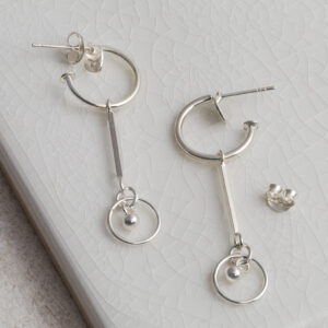 Sterling Silver Heart and Bar Studs on a white tile background.