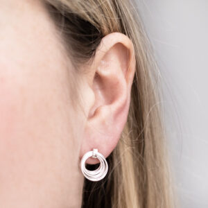 Sterling Silver Layered Hoops Studs worn by a model.