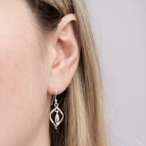 Sterling Silver Twirl Dangly Earrings worn by a model.