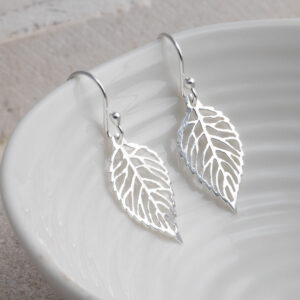 Sterling Silver Leaf Dangly Earrings earrings on a white shell background.