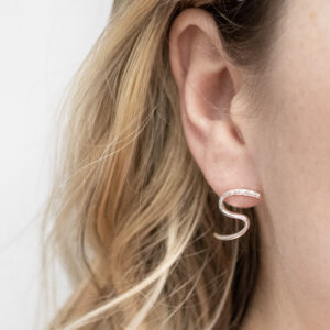 Sterling Silver Swirly Curly Studs worn by a model.