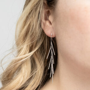 Sterling Silver Dancing Bar Studs worn by a model.