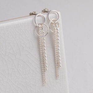 Sterling Silver Curb and Bead Dangly Studs on a white tile background.