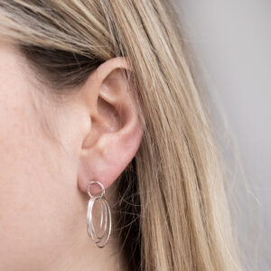 Sterling Silver Hoola Hoop Studs worn by a model.