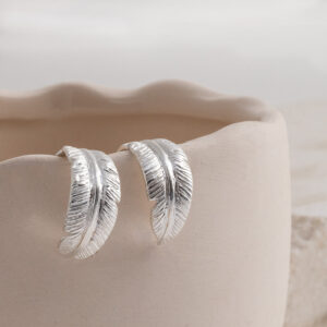 Sterling Silver Feather Hoop Studs on a cream background.
