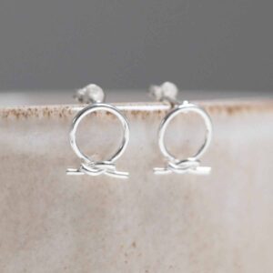 Sterling Silver Circle Knot Studs on stone background