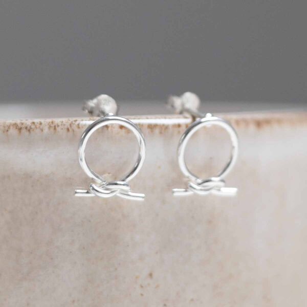 Sterling Silver Circle Knot Studs on stone background