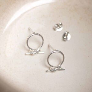 Sterling Silver Circle Knot Studs on stone background