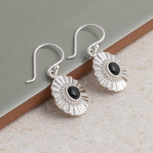 Sterling silver Onyx sun disc earrings on a green title background.