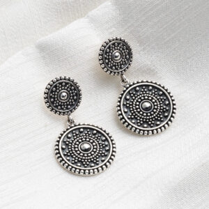 Sterling silver oxidised double Marrakech stud earrings with intricate detailing and a darkened antique finish on a white fabric textured background.