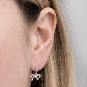 Sterling Silver Bow Drop Earrings worn by a model.