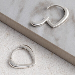 Sterling silver pear-shaped hoop earrings with a smooth, polished finish, displayed on a grey tile background.
