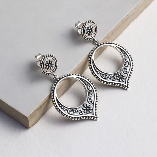 Sterling silver Harbala dangly stud earrings featuring Moroccan design with elegant hoop drop detailing on a grey title.