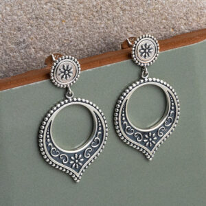 Sterling silver Harbala dangly stud earrings featuring Moroccan design with elegant hoop drop detailing with a sage green tile background