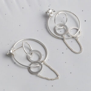 Sterling Silver Two Way Circle Studs on a spotted white background.