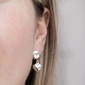 Sterling Silver Heart Droplet Studs on a model.