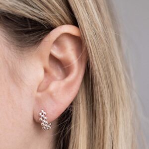 Sterling Silver Triple Swinging Bead Studs on a model.
