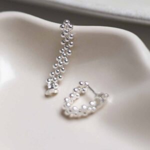Sterling Silver Triple Swinging Bead Studs in jewellery dish