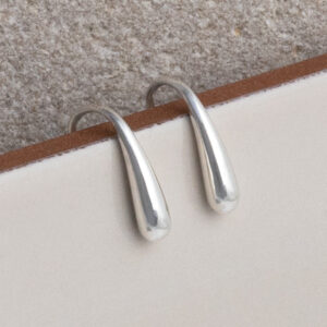 Sterling Silver Mini Liquid Drop Earrings on a cream background.