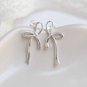 Sterling Silver Ribbon Bow Studs on jewellery dish