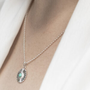 Sterling silver Turquoise sun disc necklace worn by a model.