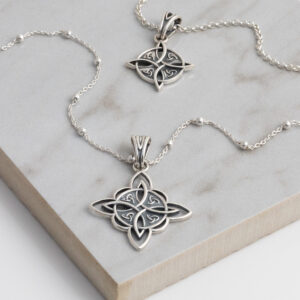 Sterling Silver Witches Necklace in small and large featuring intricate detailing and a oxidised finish on a grey title.