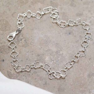 Sterling Silver Shimmer Clover Anklet on stone background