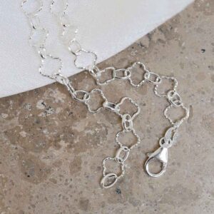 Sterling Silver Shimmer Clover Anklet on stone background