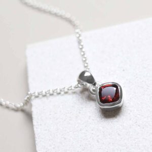 Sterling Silver Garnet Birthstone Necklace on tile