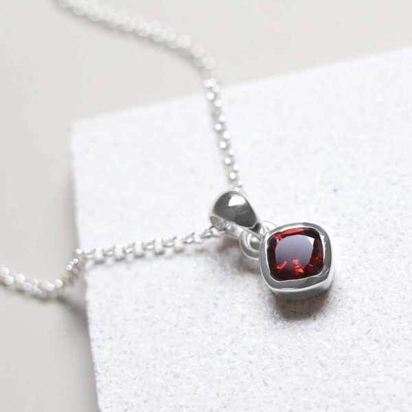 Sterling Silver Garnet Birthstone Necklace on tile
