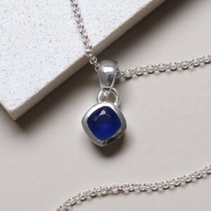 Sterling Silver Iolite Birthstone Necklace on tile