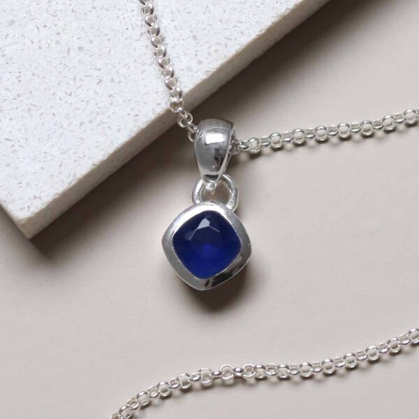 Sterling Silver Iolite Birthstone Necklace on tile
