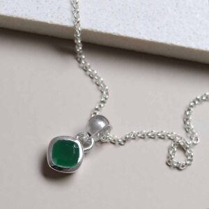 Sterling Silver Emerald Birthstone Necklace on tile