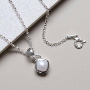 Sterling Silver Pearl Birthstone Necklace on tile