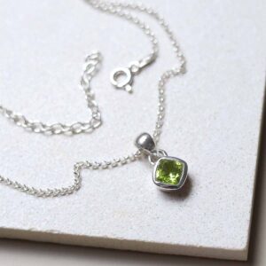 Sterling Silver Peridot Birthstone Necklace on a tile
