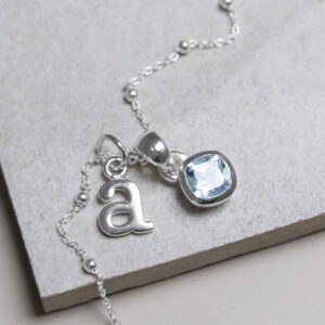 Sterling Silver Blue Topaz Birthstone Necklace on a satellite chain with a letter add on charm