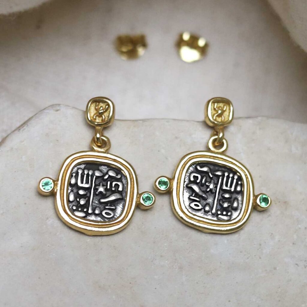 Gold Plated Sterling Silver Hieroglyphics Square Earrings on cream fabric background.