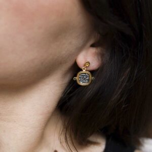 Gold Plated Sterling Silver Hieroglyphics Square Earrings on a model with brown hair.
