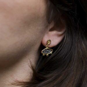 Gold Plated Sterling Silver Hieroglyphics Earrings worn by a model with brown hair.