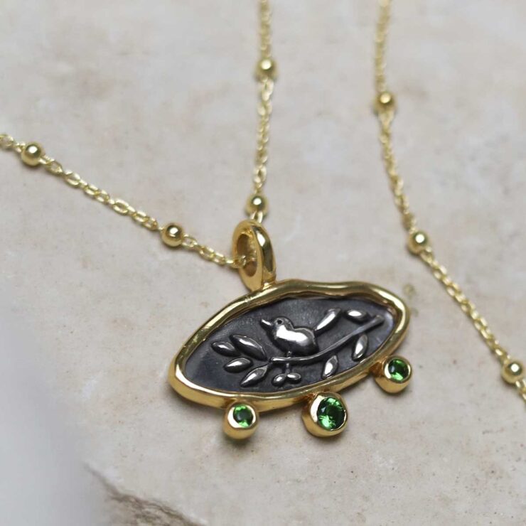 MZB150P_Gold Plated Sterling Silver Hieroglyphics Necklace_5 Gold Plated Sterling Silver Hieroglyphics Necklace on beige fabric background.