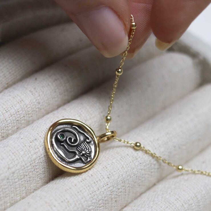 Gold Plated Sterling Silver Mermaid Necklace on beige background