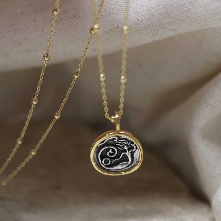 Gold Plated Sterling Silver Mermaid Necklace on beige background