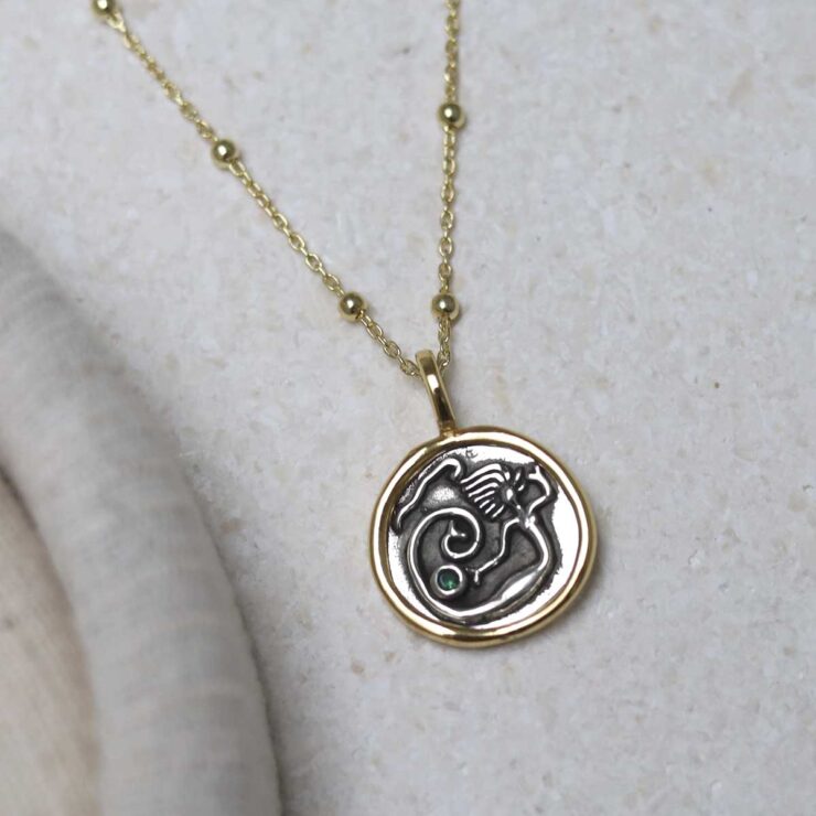 Gold Plated Sterling Silver Mermaid Necklace on beige background