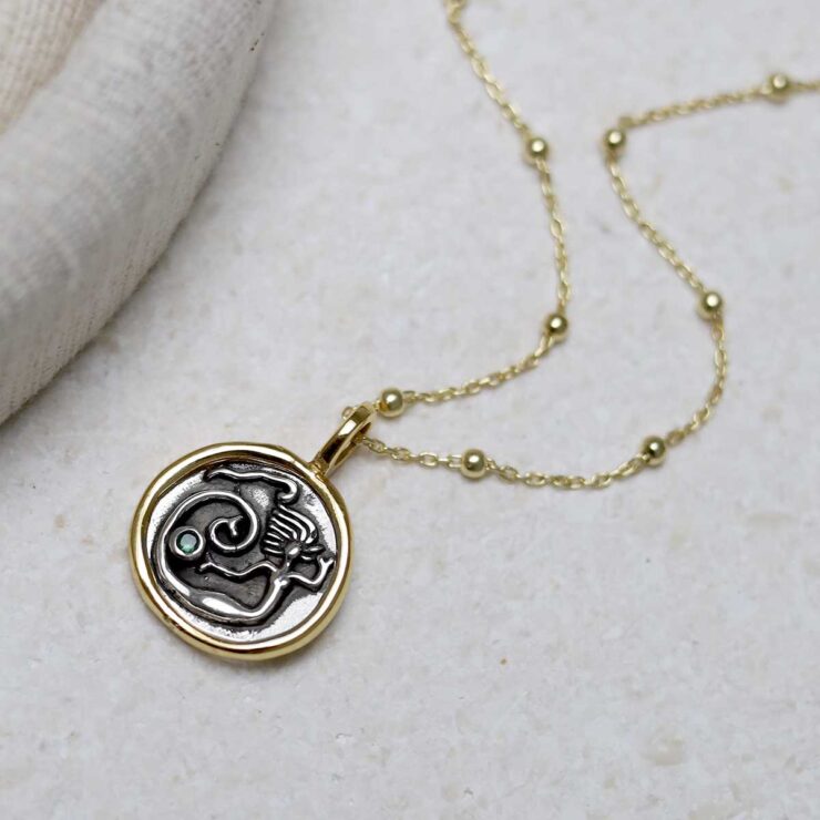 Gold Plated Sterling Silver Mermaid Necklace on beige background