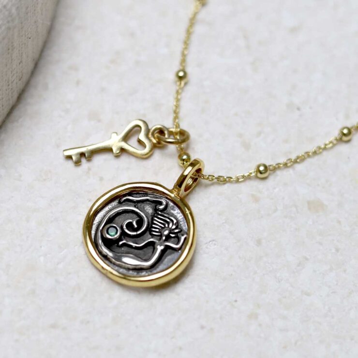 Gold Plated Sterling Silver Mermaid Necklace with gold key charm on beige background